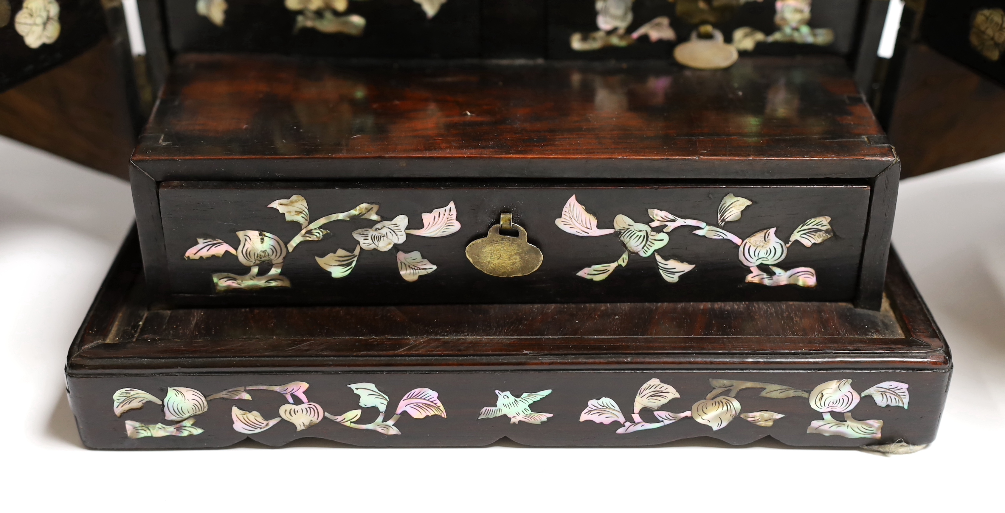 A Chinese mother-of- pearl inlaid hongmu vanity cabinet, late Qing dynasty, with fitted interior comprising a mirror, drawers, etc. 24cm x 31cm x 20cm